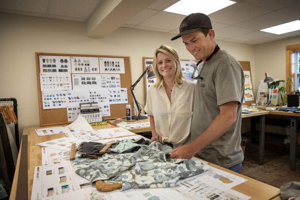 Levitate owners Jess and Dan Hassett look at samples at their design studio in Marshfield. (Robin Lubbock/WBUR)