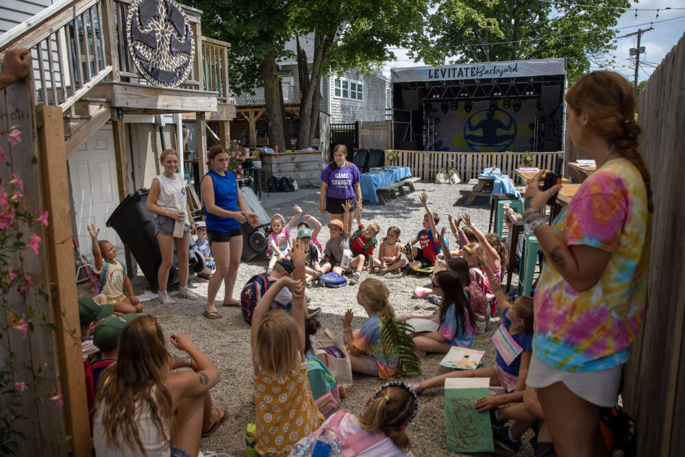 Creative camp kids play a game in the Levitate backyard in Marshfield. (Robin Lubbock/WBUR)