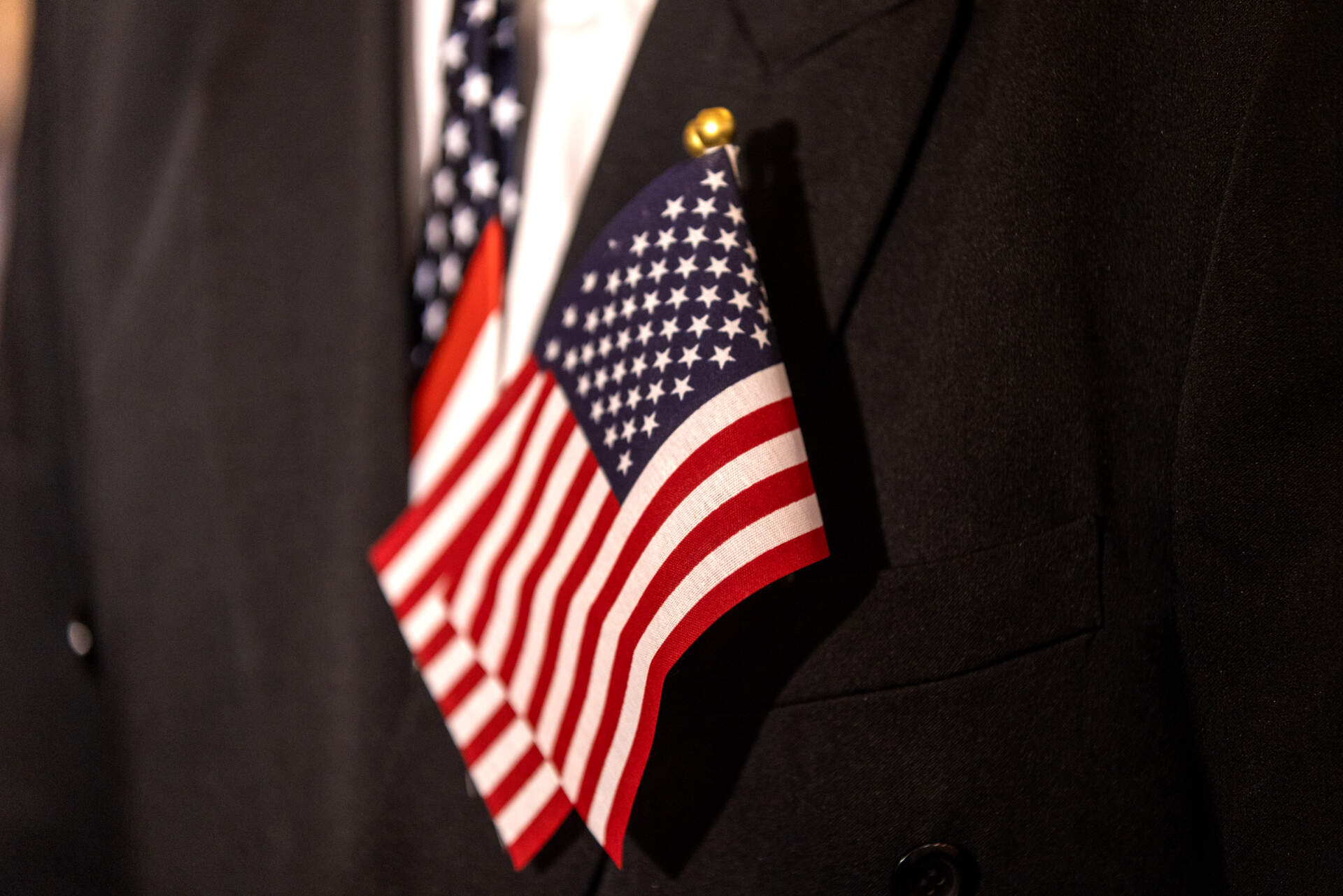 Two small American flags sit in the front pocket of naturalization applicant Luis Rubio of El Salvador. (Jesse Costa/WBUR)