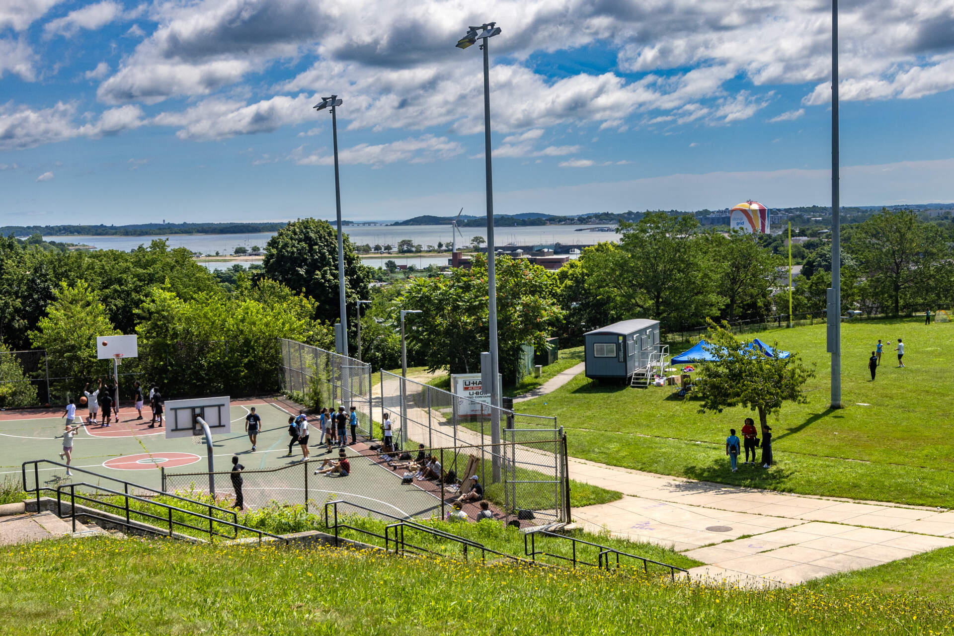 A view of Dorchester Bay while children play at Ronan Park. (Jesse Costa/WBUR)