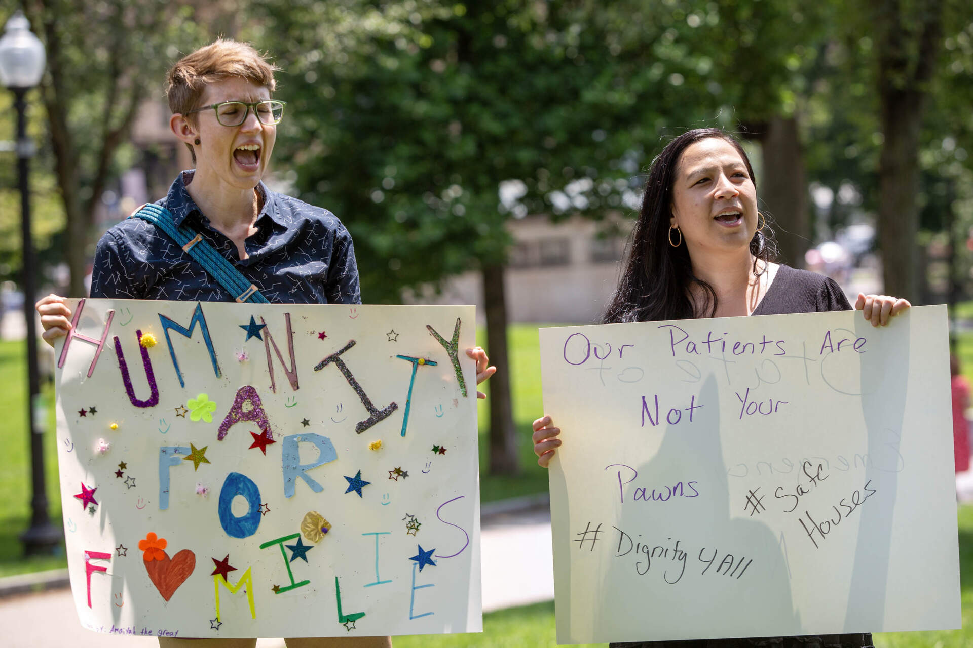 Health care and community workers rally on Boston Common by the Massachusetts State House demanding that state and federal agencies provide greater support for migrants and asylum-seekers. (Robin Lubbock/WBUR)