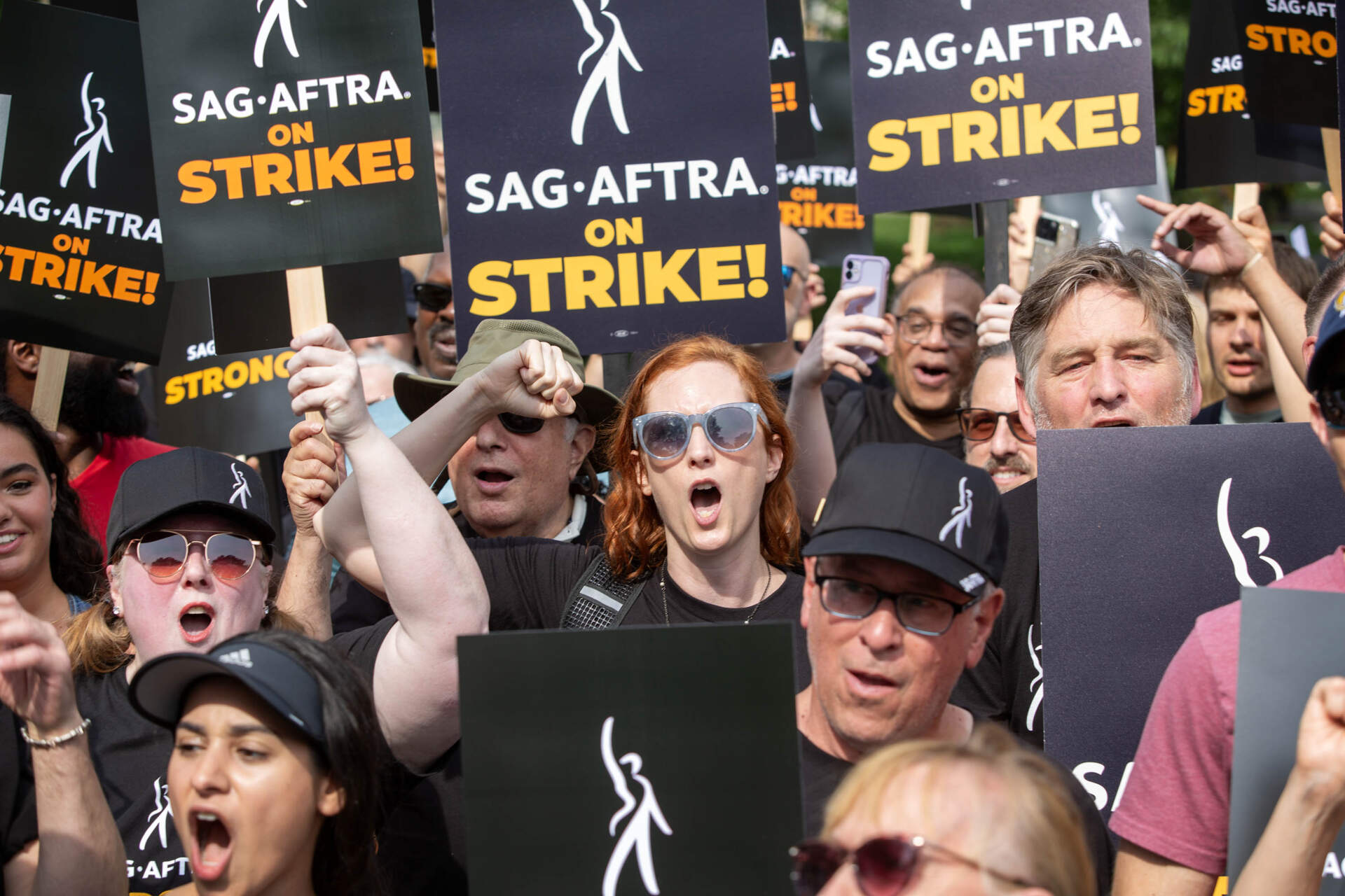 SAG-AFTRA members and supporters chant during a rally on Boston Common. (Robin Lubbock/WBUR)