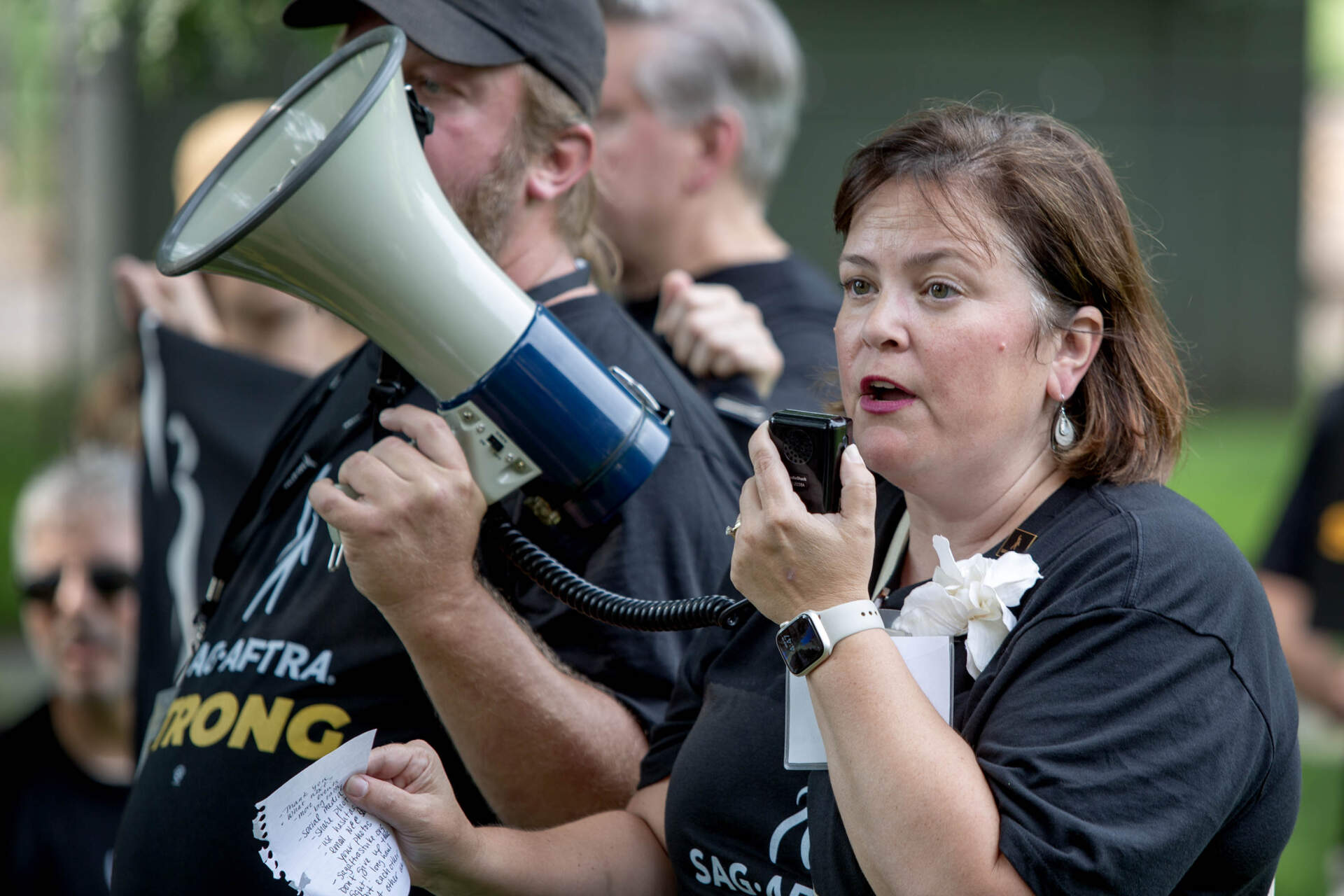 SAG-AFTRA New England Executive Director Jessica Maher talks with striking union members on Boston Common. (Robin Lubbock/WBUR)