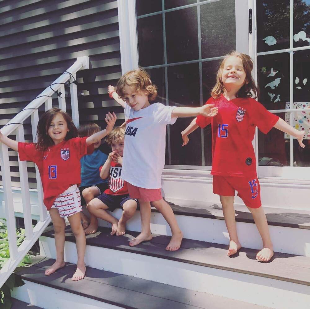 Two of the author's daughters (in red) and their friends impersonating Megan Rapinoe's pose at World Cup final watch party on July 7, 2019. (Courtesy Cloe Axelson)