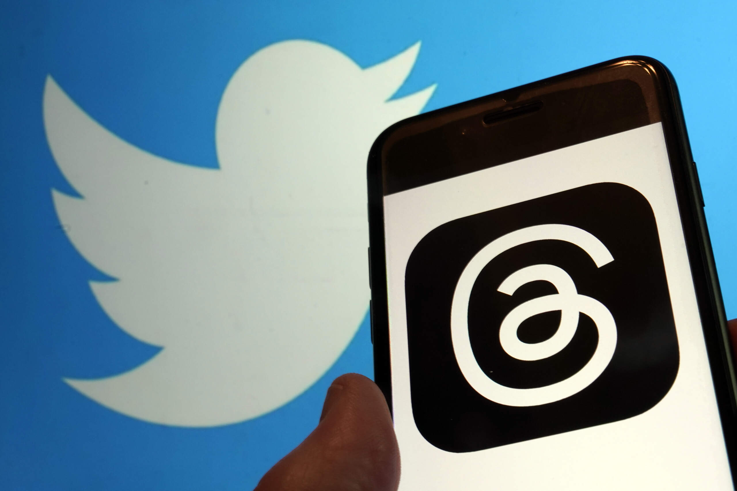 The logo for Meta's new app Threads, right, and that of Twitter. (Richard Drew/AP)