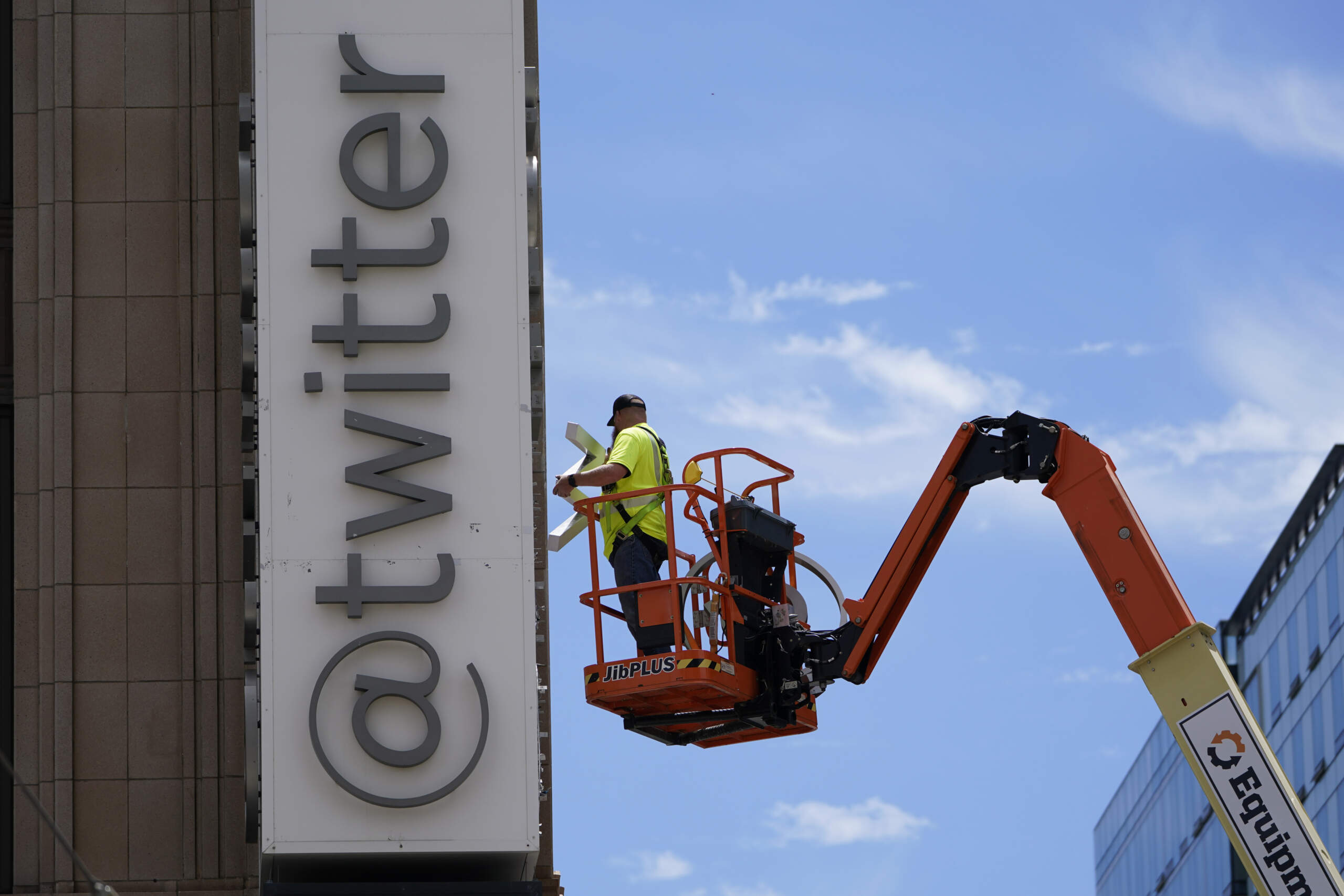 A workman removes a character from a sign on the Twitter headquarters building in San Francisco. Elon Musk has unveiled a new "X" logo to replace Twitter's famous blue bird as he follows through with a major rebranding of the social media platform he bought for $44 billion last year. (Godofredo A. Vásquez/AP)