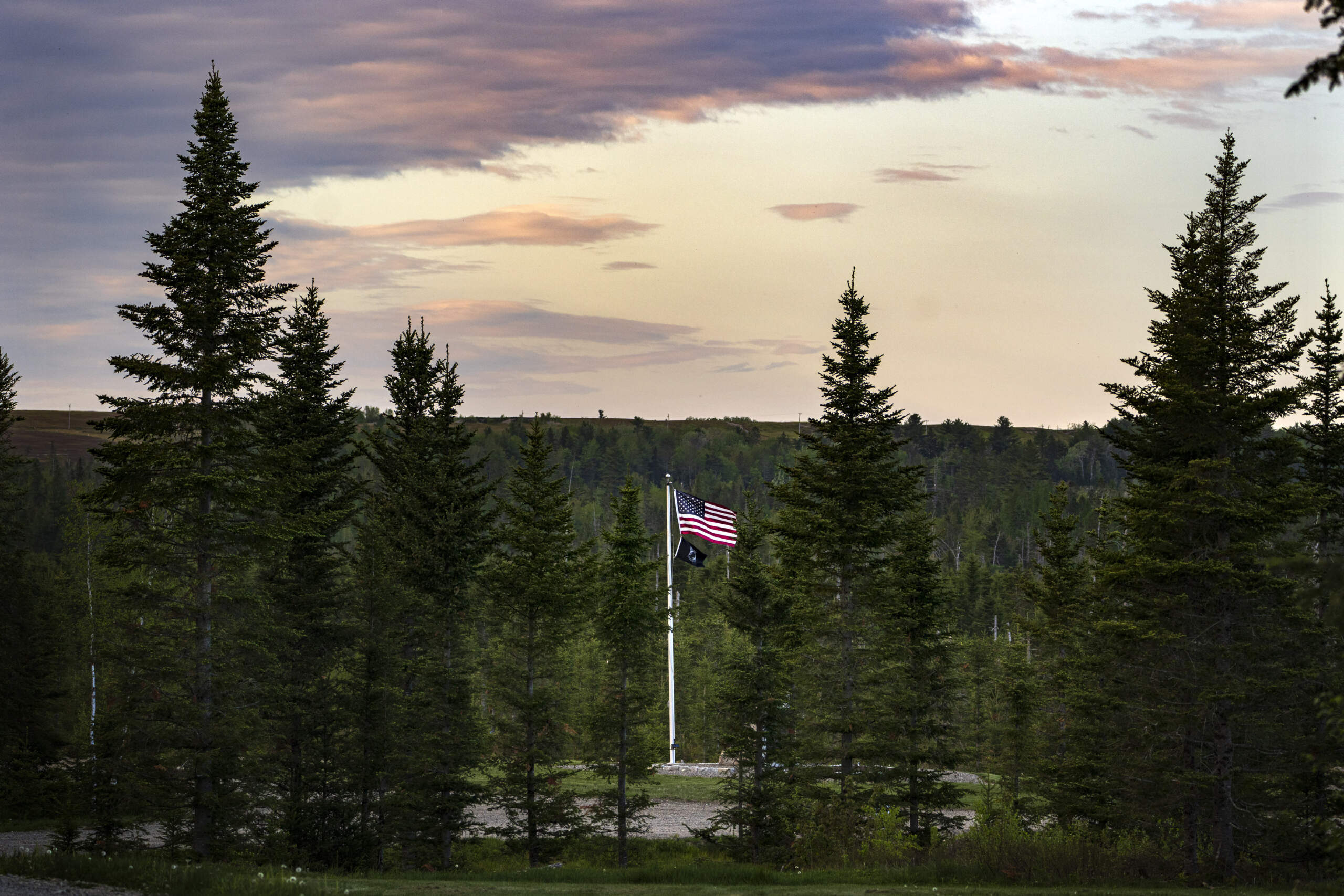 A U.S. flag flies at Patriot Park where a collection of monuments stand in tribute to veterans in Columbia Falls, Maine. A family hopes to build a $1 billion theme park nearby. (Robert F. Bukaty/ AP)