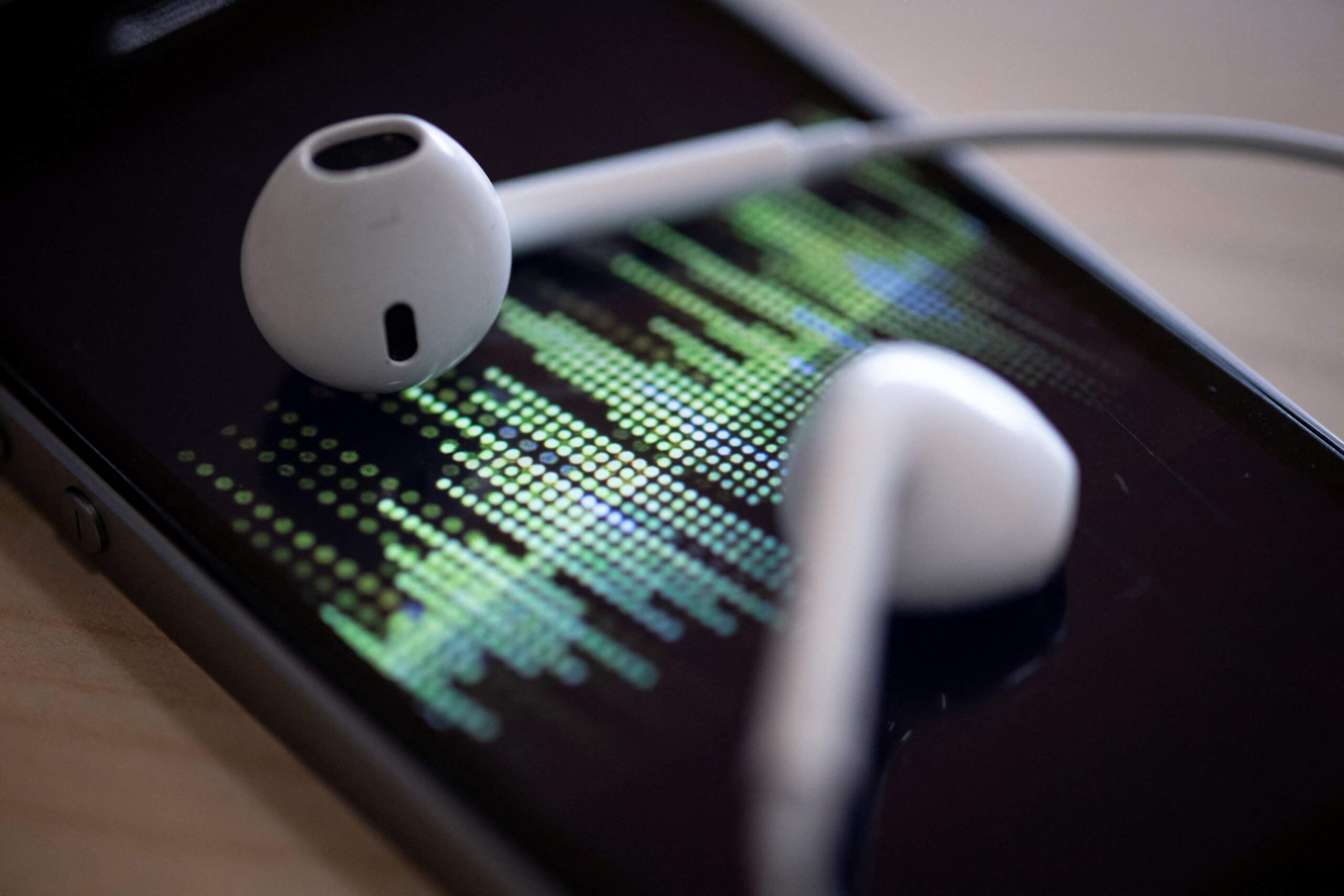 A smartphone and its earphones as an audio podcast is being played. (Thomas Samson/AFP via Getty Images)