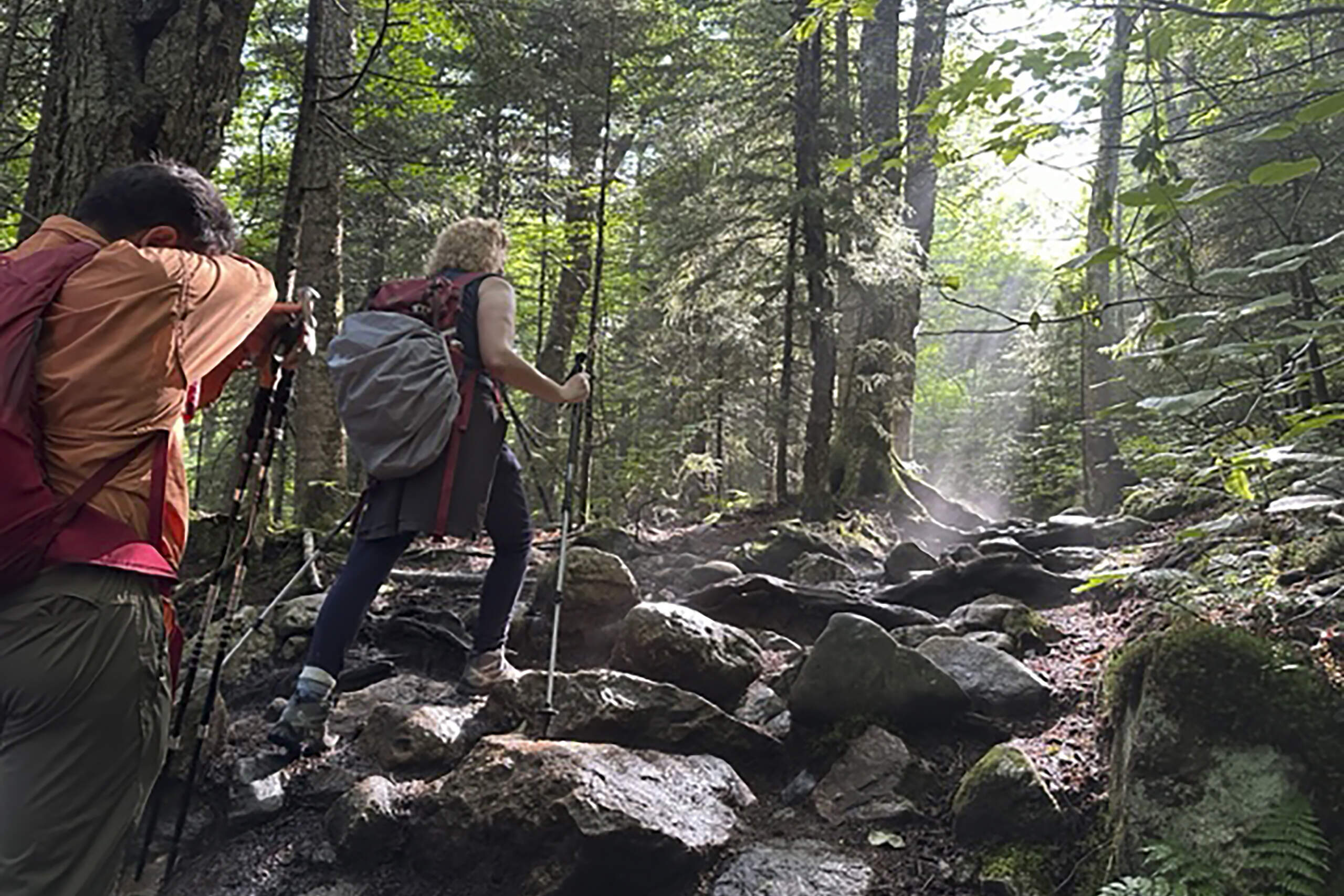 Jorge Sotelo, left, and Olivera Bogunovic, right, make their way up New Hampshire's Mount Pierce, in Coos County, N.H., Saturday, July 8, 2023. The Massachusetts couple have organized a fundraising hike set for July 29 to honor their daughter Emily, who died while hiking in November of 2022. (Holly Ramer/AP)