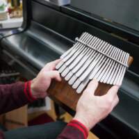 Composer Eric Shimelonis playing the mbira. (Courtesy of Rebecca Sheir)