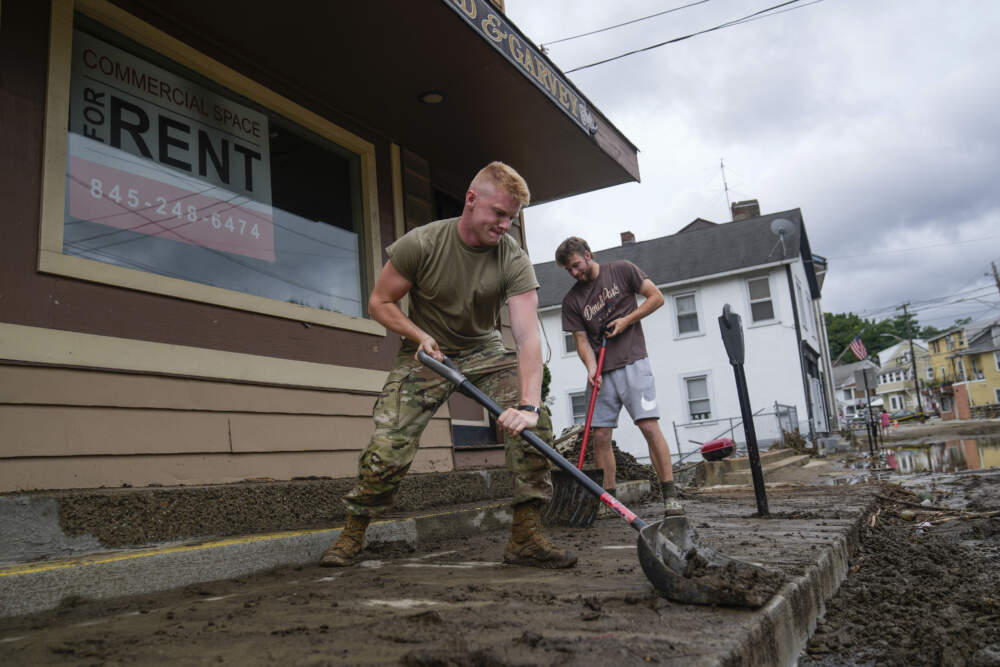 Volunteers help clear Main Street of debris after floodwaters subsided, July 10, 2023, in Highland Falls, N.Y. (John Minchillo/AP)