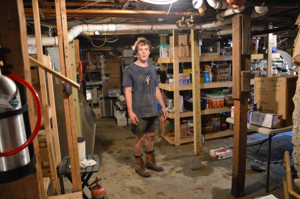 Orion Jones was visiting Cavendish, Vermont for the weekend and couldn't leave because of the flooding. So he and a group of friends have spent the last several days helping businesses in Ludlow clean up. (Nina Keck/Vermont Public)