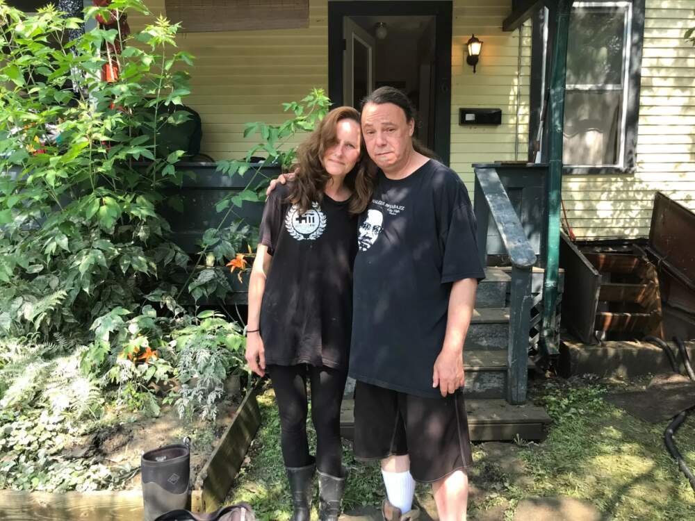 Billiejo and Ian Quinlan outside their two-story apartment on Elm Street in Montpelier on Wednesday. (Peter Hirschfeld/Vermont Public)