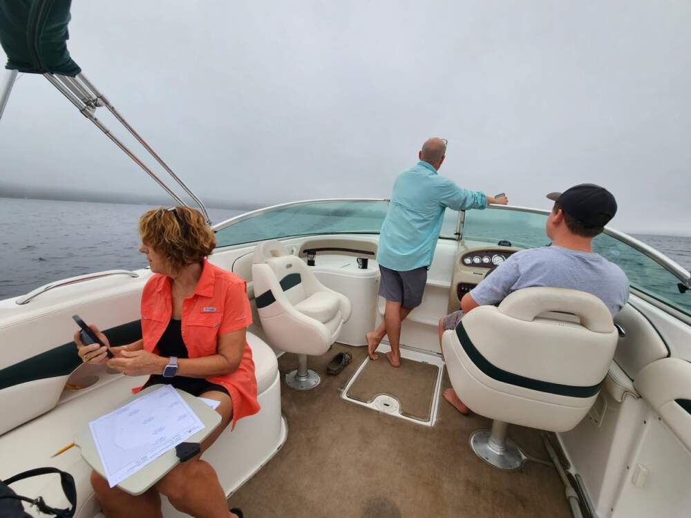 The Bruni family on their boat in Jordan Bay on Sebago Lake on July 15, 2023. (Susan Sharon/Maine Public)