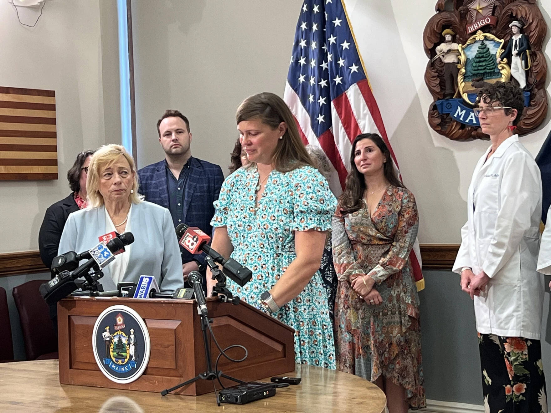 Gov. Janet Mills watches July 19, 2023 as Dana Peirce of Yarmouth talks about having to travel out of state to obtain an abortion late in her pregnancy after the fetus was diagnosed with a fatal condition. (Kevin Miller/Maine Public)