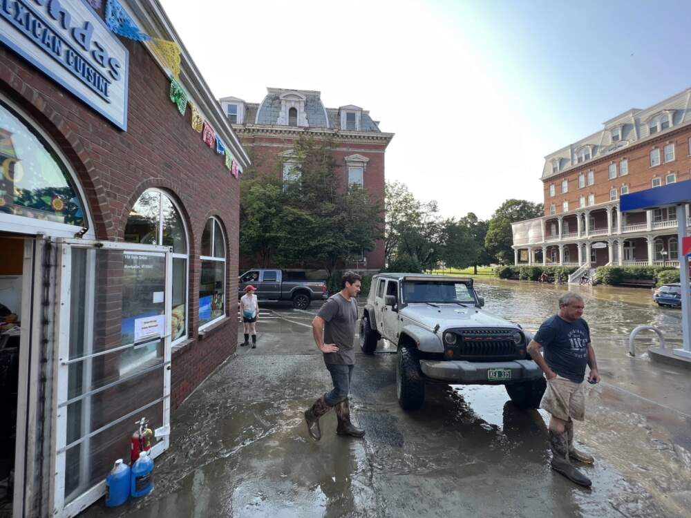 On Tuesday evening, Dave Simendinger (right) stands outside one of the many gas stations that he owns in the region and assesses the damage with his son Kurt. (Brian Stevenson And Kyle Ambusk/Vermont Public)