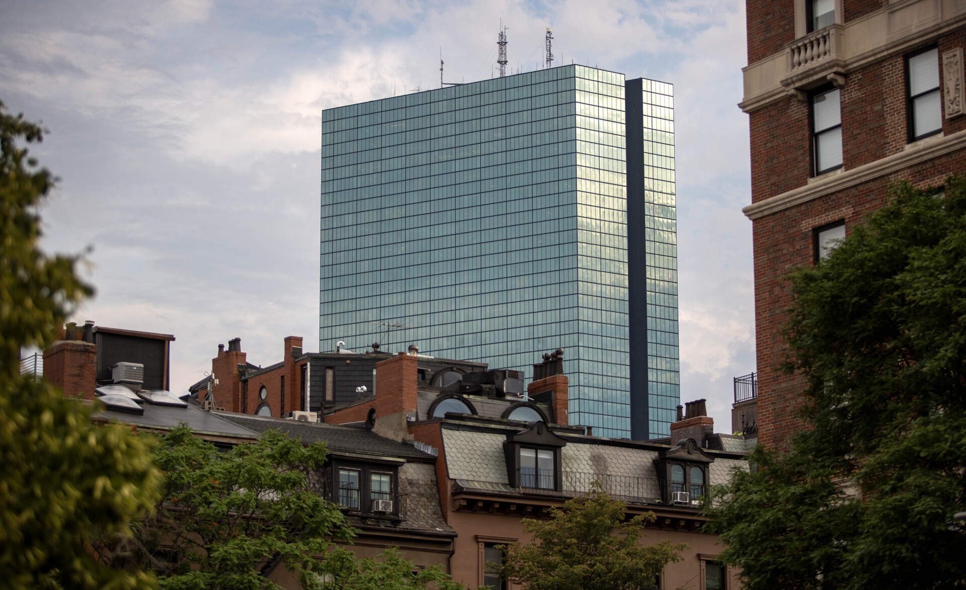 Pictured are Back Bay brownstones and 200 Clarendon Street, previously the John Hancock Tower. (Robin Lubbock/WBUR)