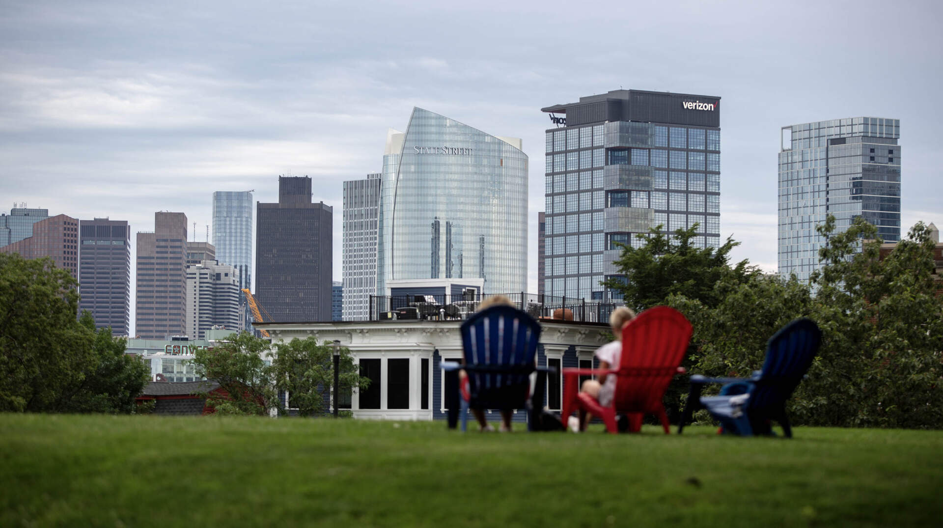 Visitors to Bunker Hill in Charlestown, look across to the buildings in downtown Boston. (Robin Lubbock/WBUR)