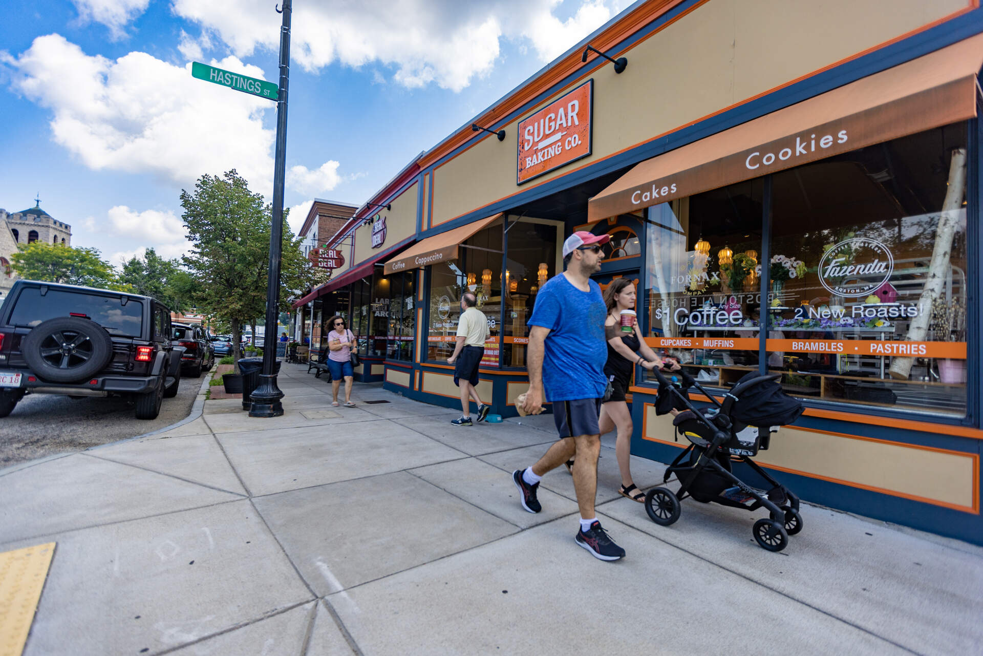 People walk past businesses on Centre Street in West Roxbury. (Jesse Costa/WBUR)