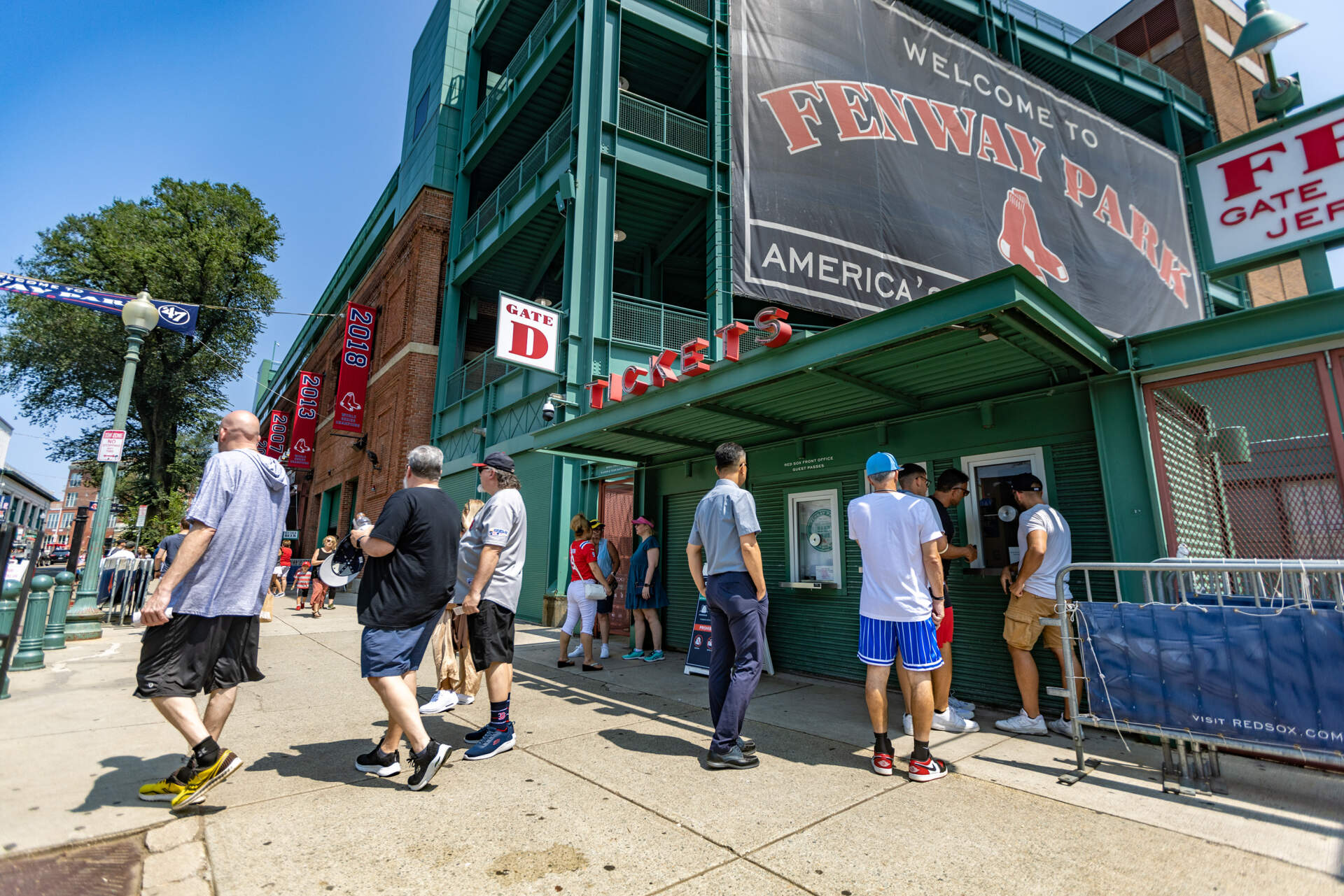 Baseball fans line up at the ticket booth at Fenway Park to purchase tickets for that day’s Red Sox game. (Jesse Costa/WBUR)