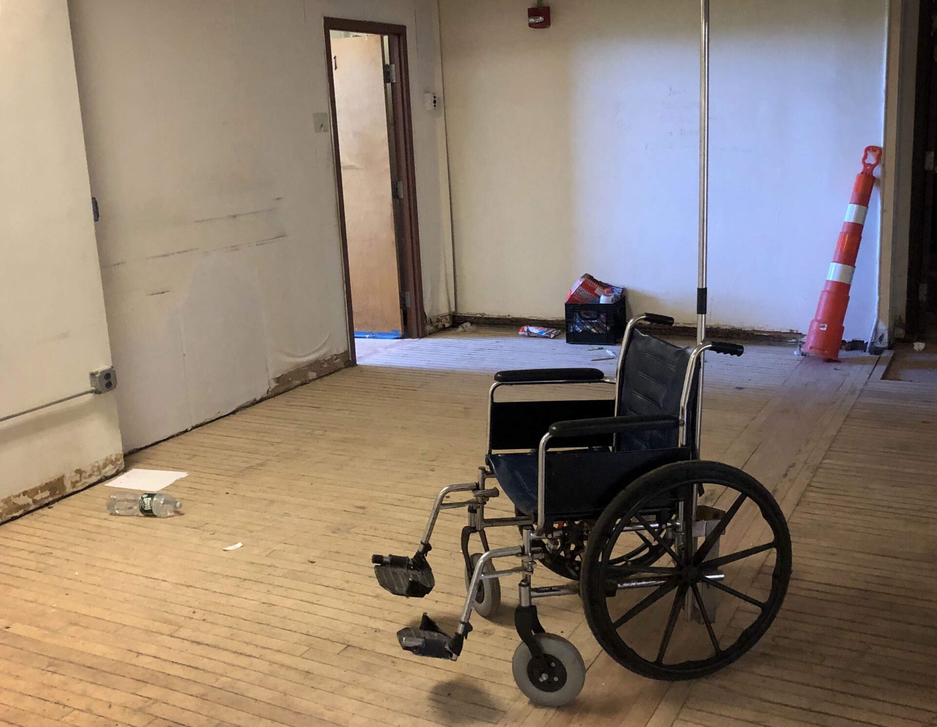 A wheelchair inside one of the now-dilapidated buildings that once served as a recovery campus on the island. (Deborah Becker/WBUR)