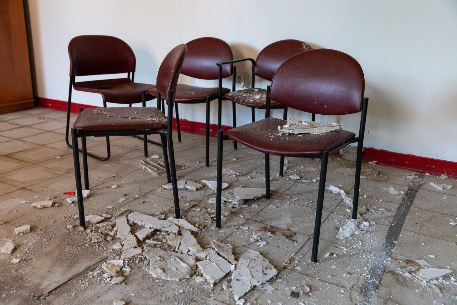 Chairs covered in dust and ceiling debris inside one of the buildings. (Mayor’s Office Photo by Mike Mejia)