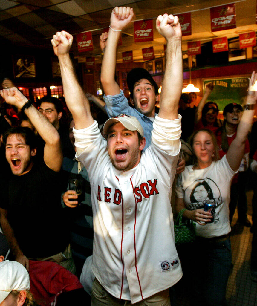 Boston Red Sox fan Brian Kramer, of Boston, center, celebrates with fellow fans as the Red Sox beat the New York Yankees in the American League playoffs, Wednesday, Oct. 20, 2004. The Red Sox played the Yankees in New York, beating them 10-3. (Steven Senne/AP)