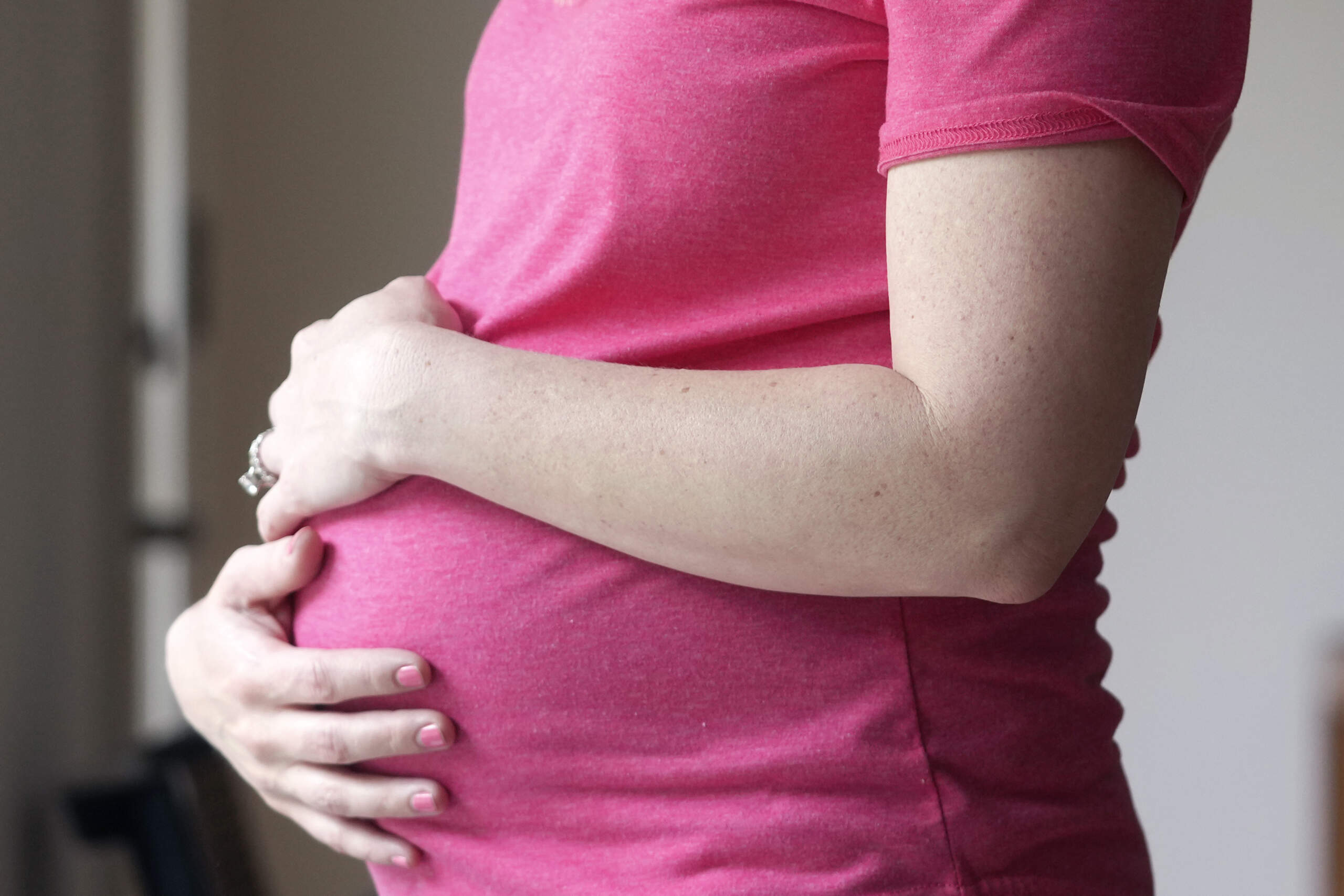 A pregnant woman stands for a portrait in Dallas, Thursday, May 18, 2023. (LM Otero/AP)