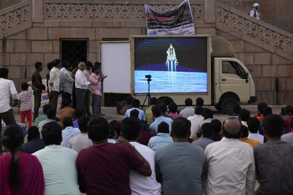 People watch the landing of Chandrayaan-3, or "moon craft" at Omani University in Hyderabad, India. (Mahesh Kumar A./AP)