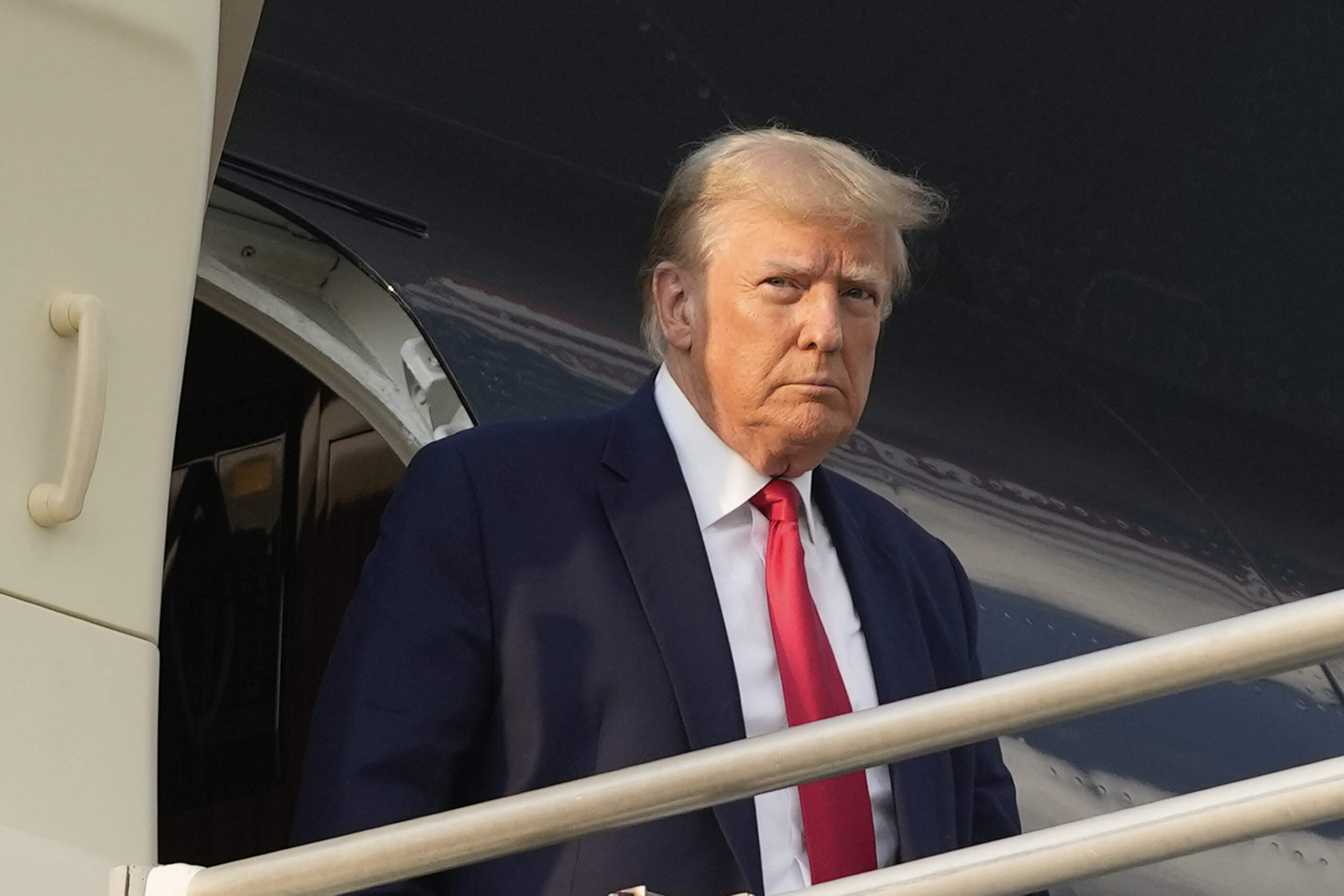 Former President Donald Trump steps off his plane as he arrives at Hartsfield-Jackson Atlanta International Airport. (Alex Brandon/AP)