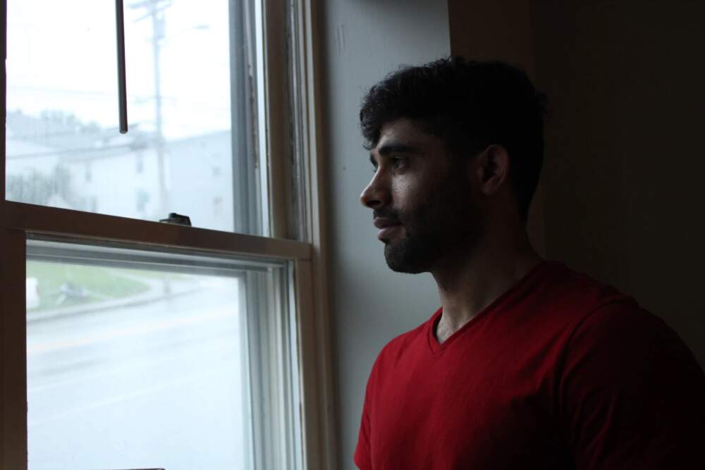 Azimullah Mohammadi at his apartment in Auburn last week. Mohammadi piloted helicopters in an elite wing of the Afghan armed forces, but says returning to flight school in the U.S. is prohibitively expensive. (Ari Snider/Maine Public)