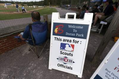 A sign indicates an area behind home plate reserved for Major League scouts during a Cape Cod League baseball game between the Chatham Anglers and the Bourne Braves, Wednesday, July 12, 2023, in Bourne, Mass.(Michael Dwyer/AP)