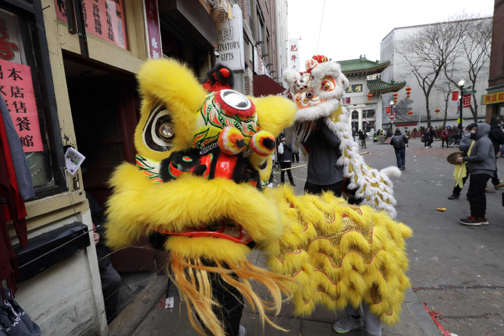 Members of Nam Pai Kung Fu Academy participate in Chinese Lunar New Year celebrations in front of a business in Chinatown. (Steven Senne/AP)