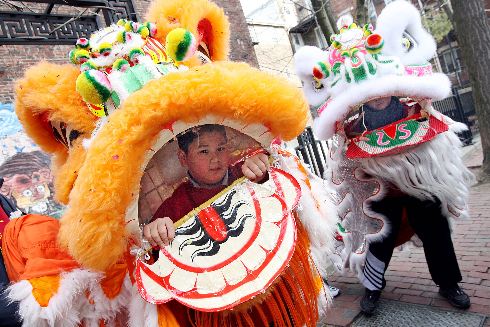 A child prepares to perform a lion dance during Lunar New Year Celebrations in Chinatown on Feb. 17, 2008. (Angela Rowlings/MediaNews Group/Boston Herald via Getty Images)