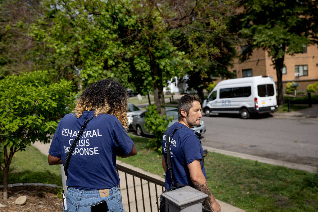 Shamso Iman, left, and Dane Haverly, with the Behavioral Crisis Response team, leave the scene after responding to a distress call in Minneapolis, Minn., on Tuesday, July 11, 2023. (Elizabeth Flores/Star Tribune via Getty Images)