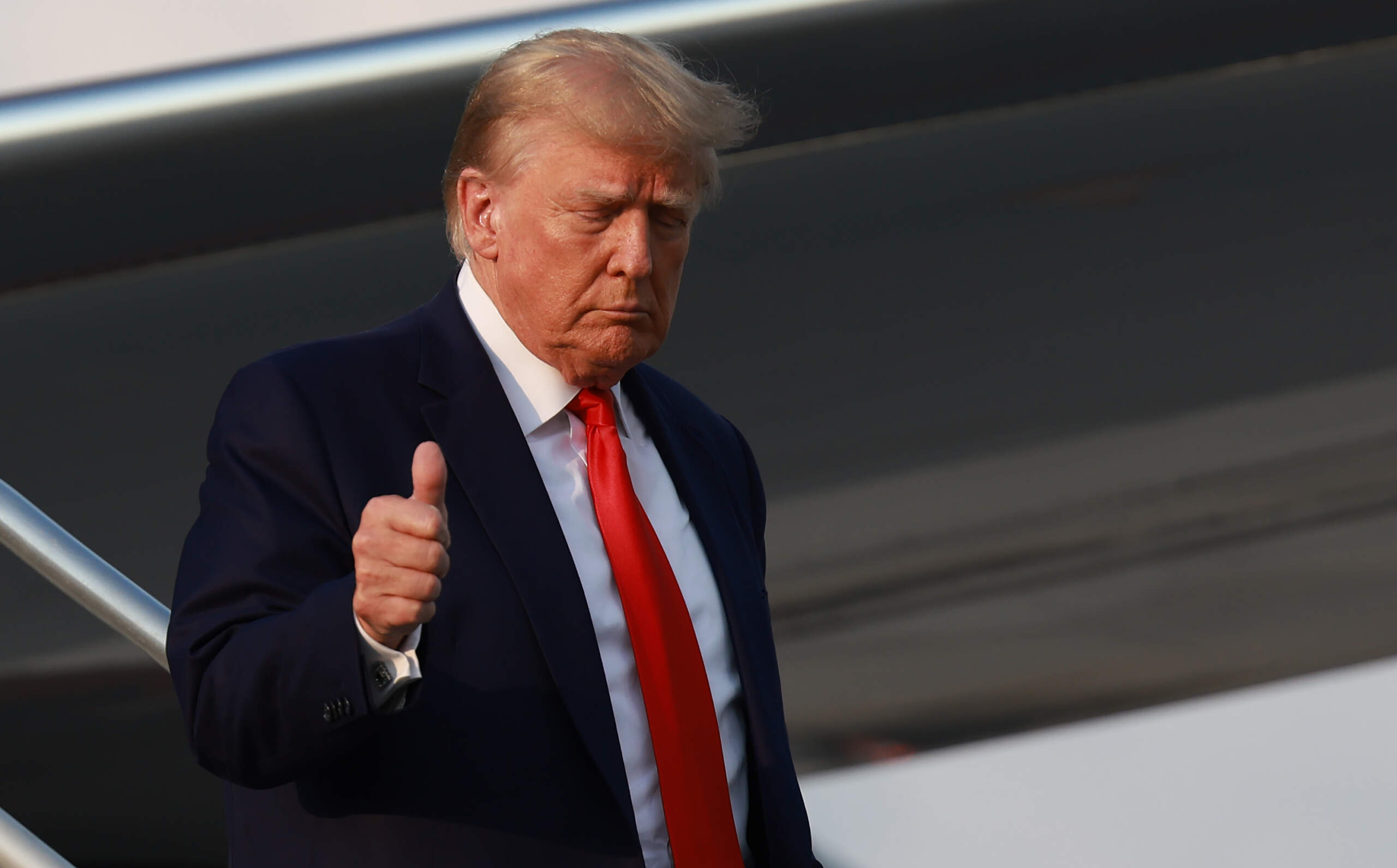 Former U.S. President Donald Trump gives a thumbs up as he arrives at Atlanta Hartsfield-Jackson International Airport in Atlanta, Georgia. (Joe Raedle/Getty Images)