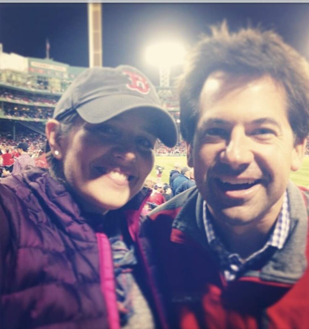 The author and her husband at a Red Sox game during the ALCS in 2013. She was pregnant with twin girls at the time. (Courtesy Cloe Axelson)