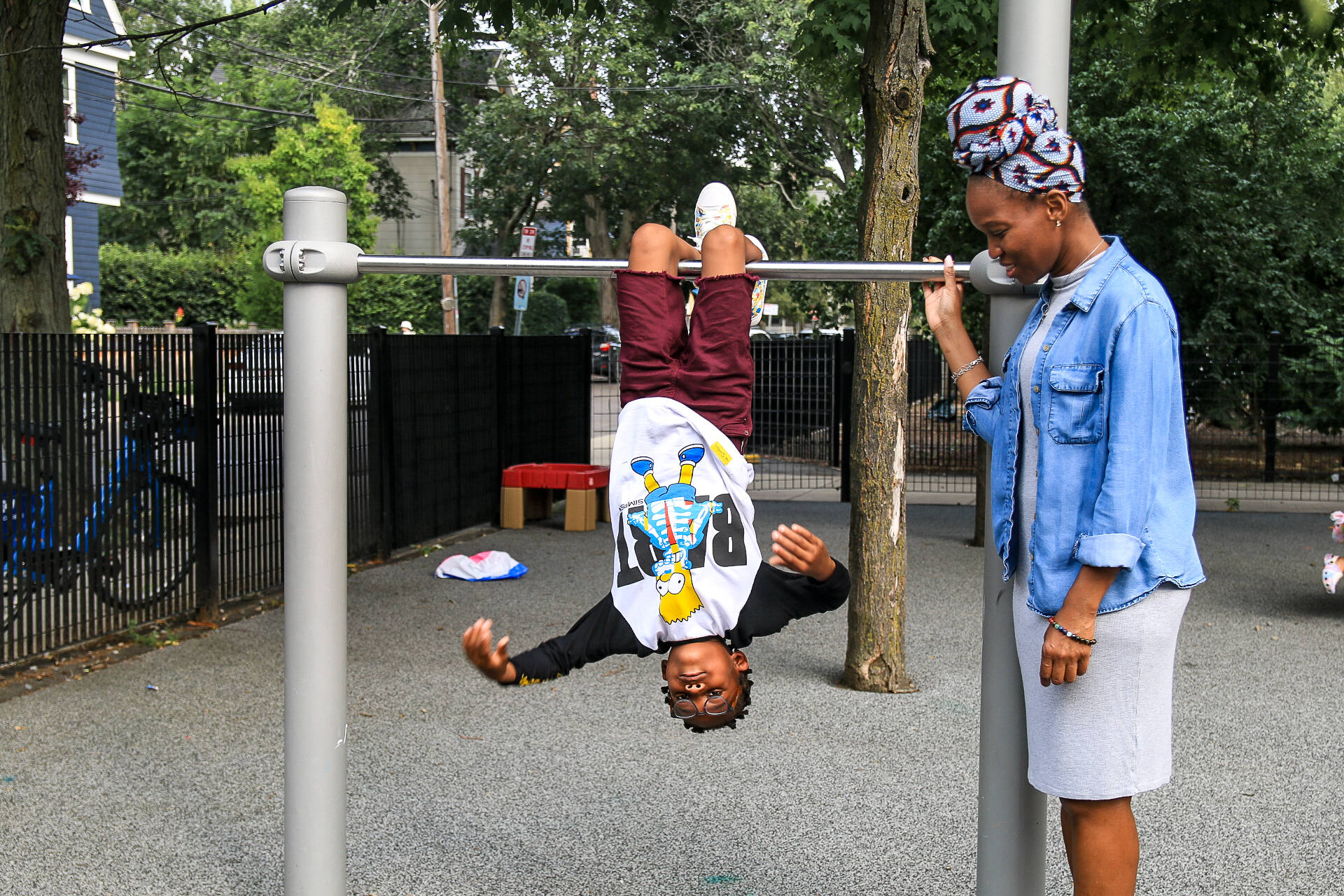 Musu-kulla Massaquoi, a Cambridge resident, and her son, TJ, at a local playground. (Emily Piper-Vallillo/WBUR)