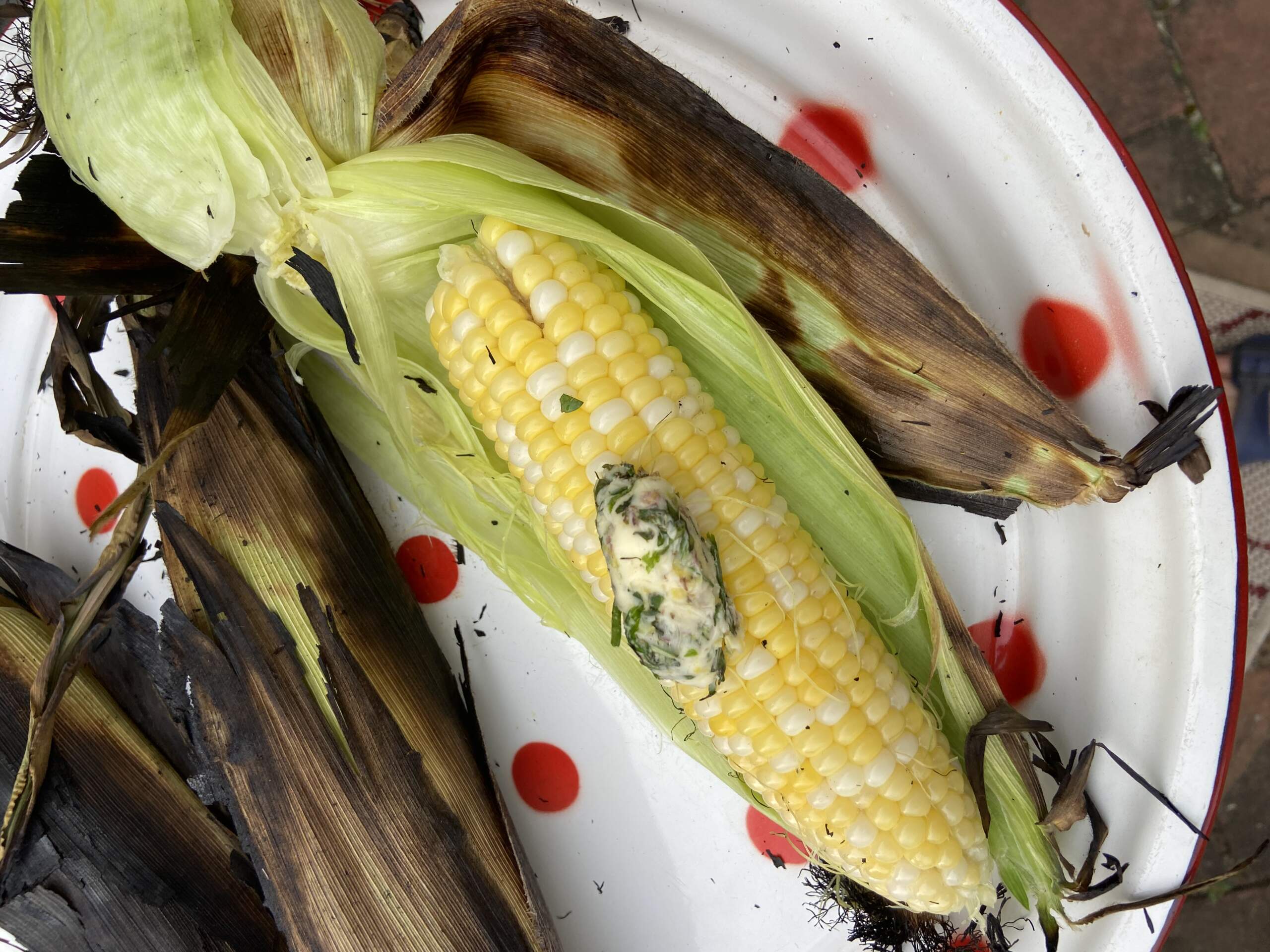 Fire-grilled corn with two seasoned butters. (Kathy Gunst/Here & Now)