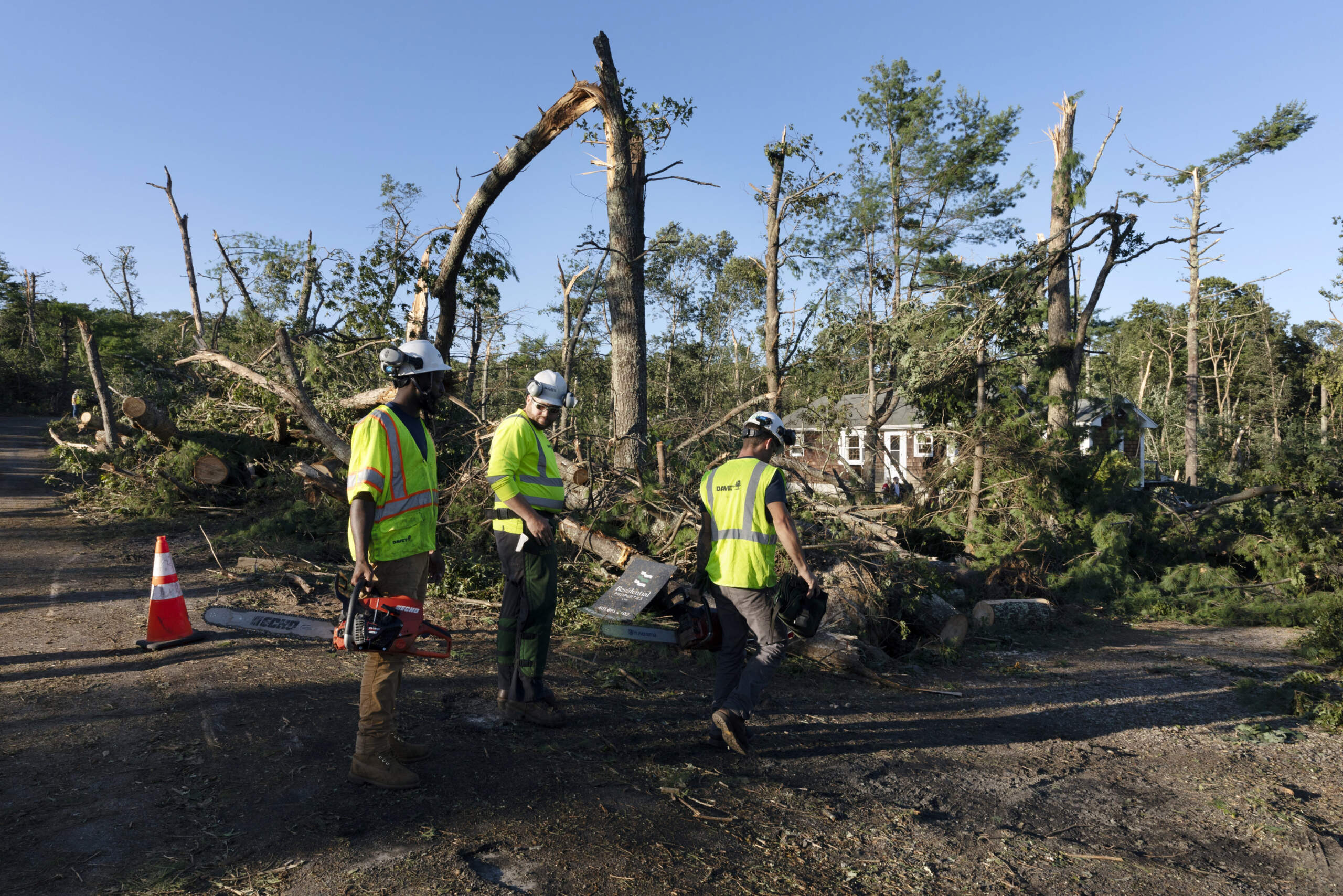 A crew works to clear downed trees, Friday, Aug. 18, 2023, in Scituate, R.I., after severe weather swept through the area. (Michael Dwyer/AP)