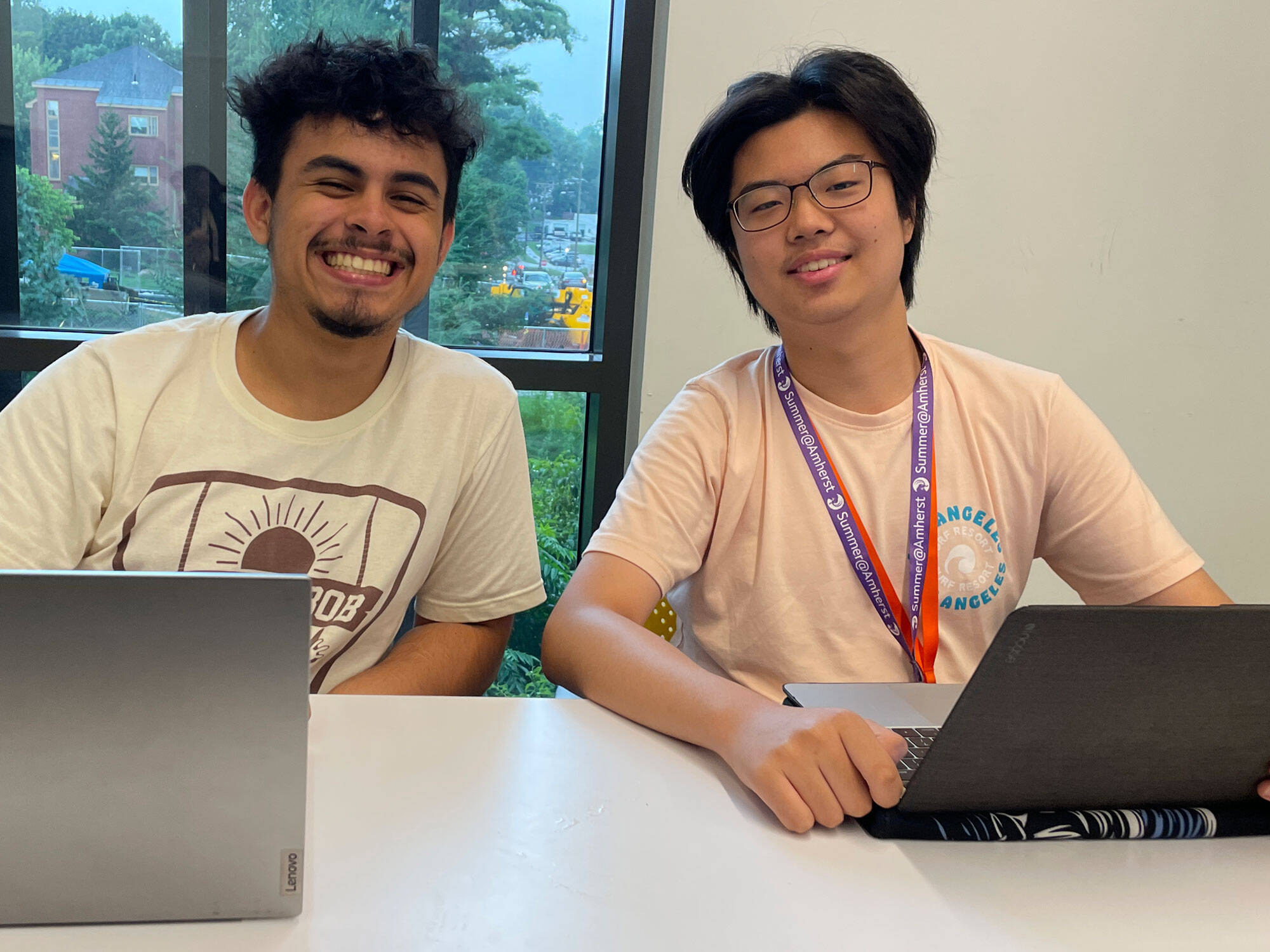 Thrive Scholars Michael Zapata, of Los Angeles, and Matthew Kim (right), of New York, work on their personal statements. (Max Larkin/WBUR)