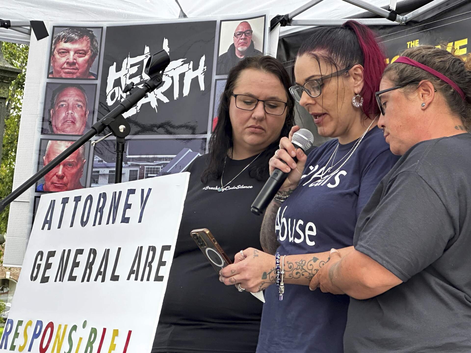 Corrine Moon, center, is comforted by other former residents of New Hampshire's youth detention center as she speaks outside the Statehouse in Concord on Friday, Aug. 25, 2023.(Holly Ramer/AP)