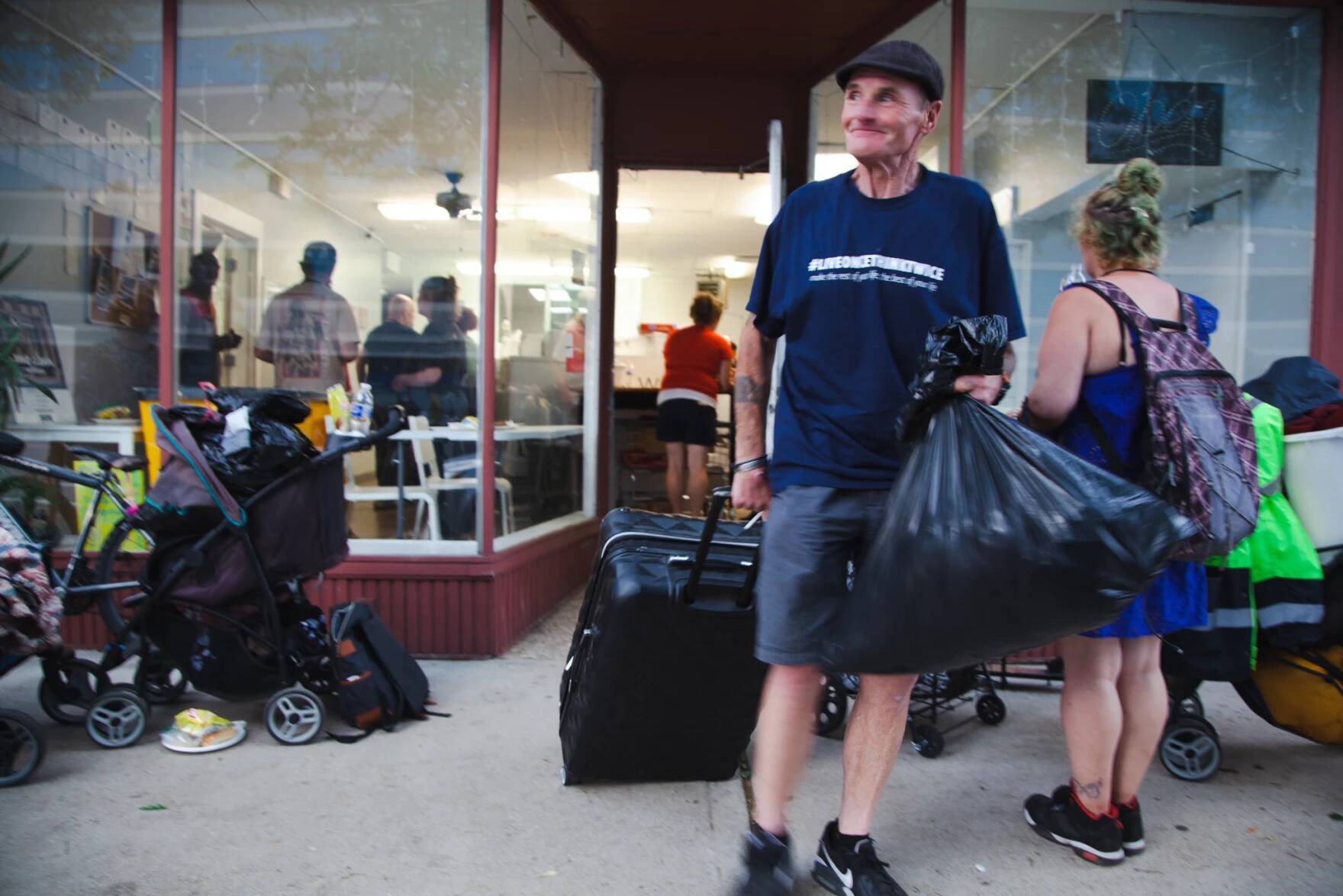 Dean Chambers leaves the laundromat with a suitcase full of clean clothes. It took him a few loads but he is thankful he didn’t have to pay for it, since he couldn't afford it otherwise. A washing and drying load can cost between $3.50 and $5. (Gabriela Lozada/NHPR)