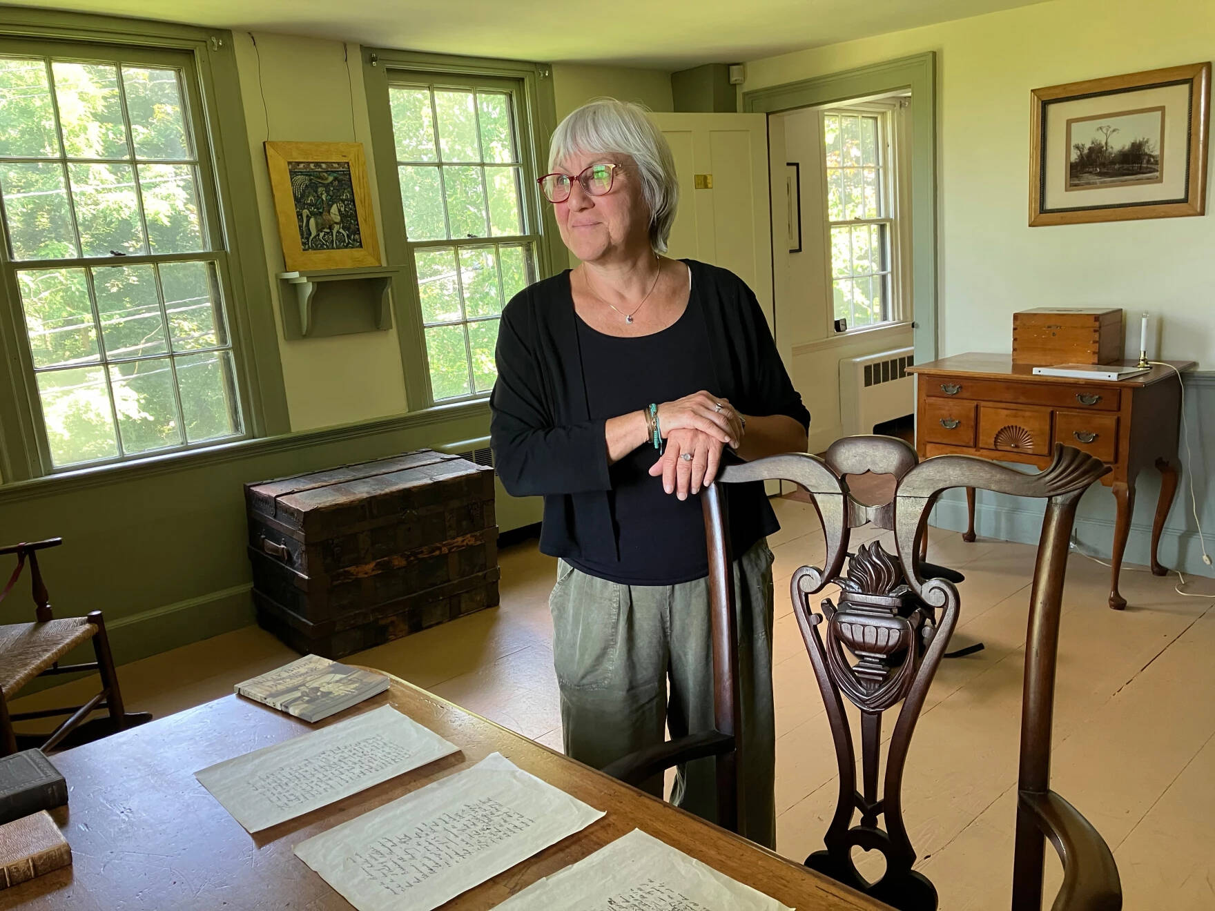 Jana Laiz stands next to a replica of Herman Melville's desk in what was once his study in Arrowhead, in Pittsfield, Massachusetts. (Nancy Eve Cohen/NEPM)