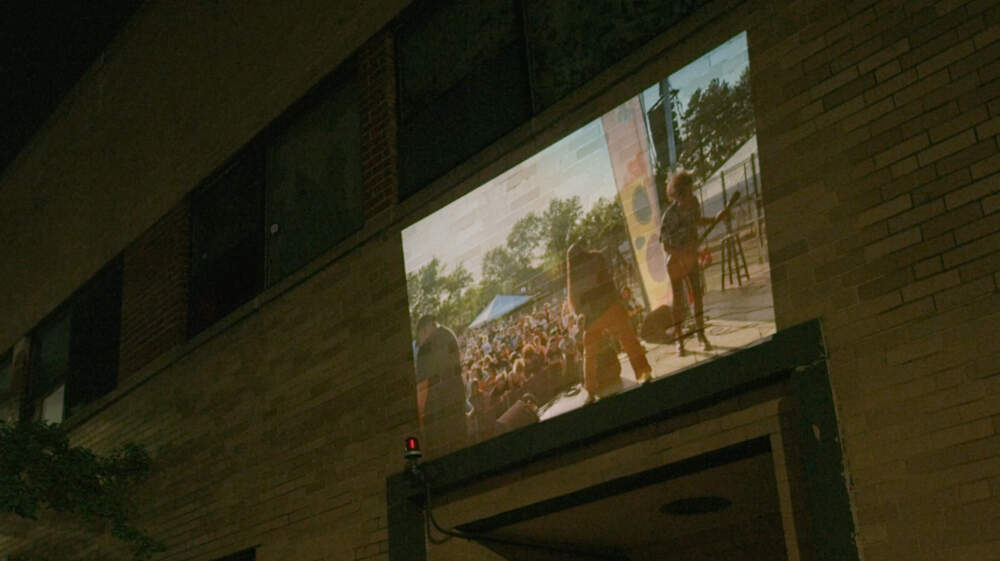 A still from the &quot;Fool's Gold&quot; music video where footage from Boston Calling is being projected on the former Sound Museum building. (Courtesy Ben Eames)