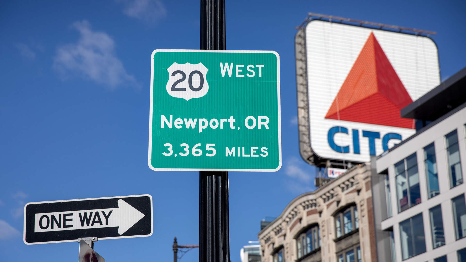 A sign in Boston's Kenmore Square tells visitors they can follow Route 20 west for 3,365 miles, all the way to Newport, Oregon. (Robin Lubbock/WBUR)