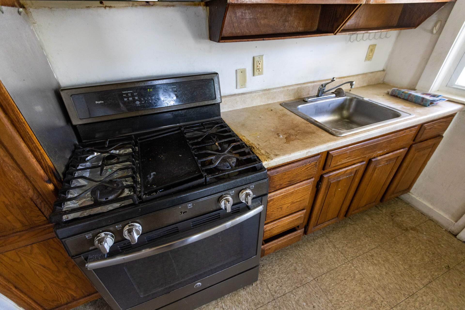 The kitchen of a unit that needs renovation in the Lexington Gardens public housing complex in Watertown. (Jesse Costa/WBUR)