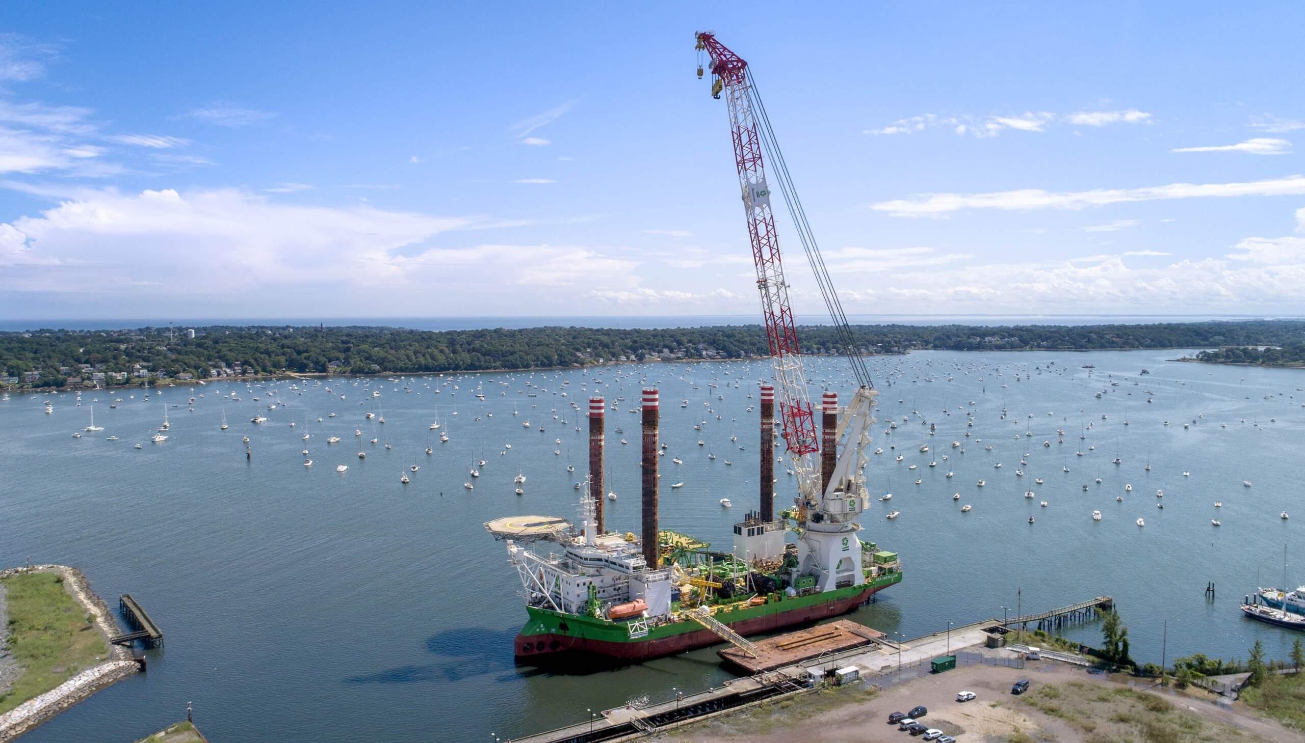 The "Sea Installer" stopped in Salem Harbor before heading out to the ocean near Martha's Vineyard, where it will install 62 massive wind turbines for Vineyard Wind. (Robin Lubbock/WBUR)