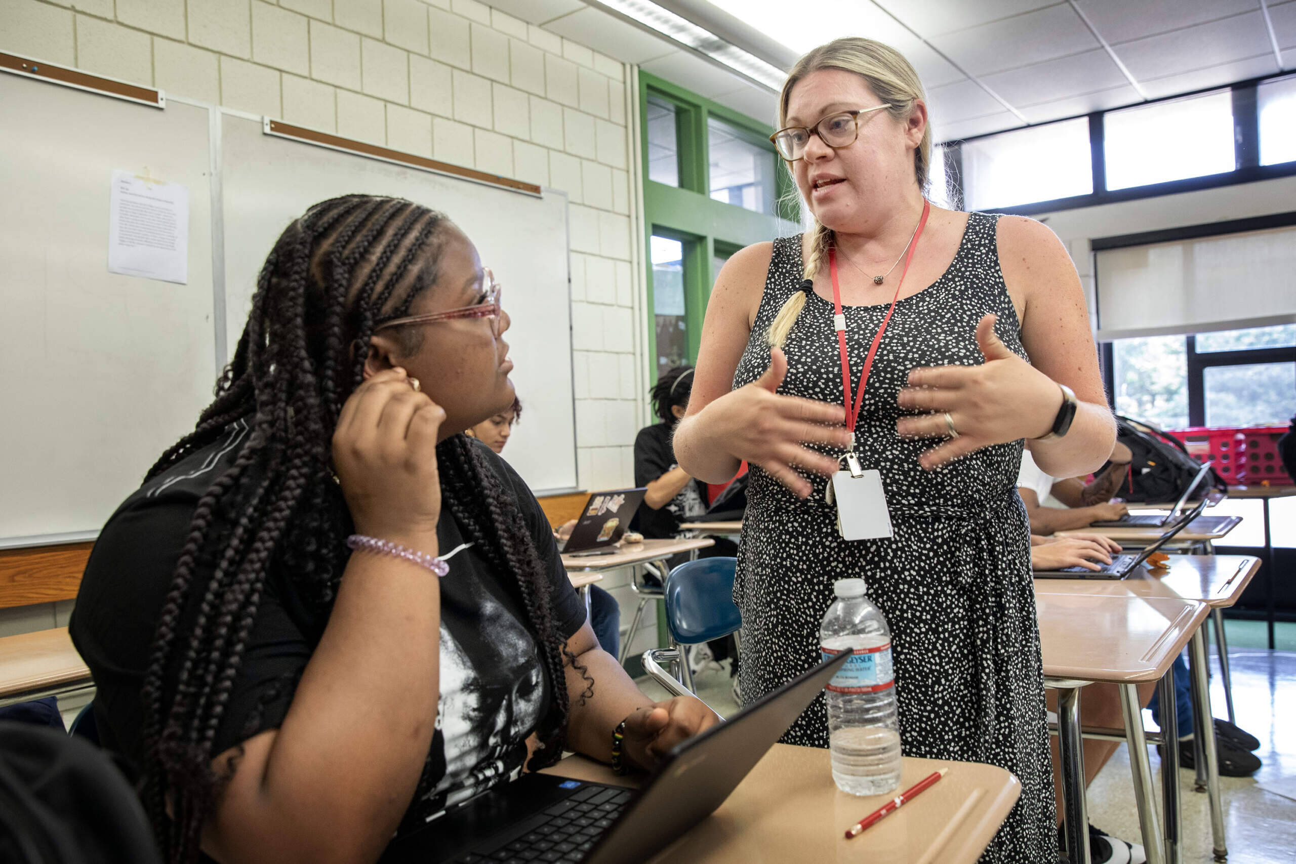 Teacher Abby Sherwood talks with a student in her English Language Arts class at Salem High School. (Robin Lubbock/WBUR)