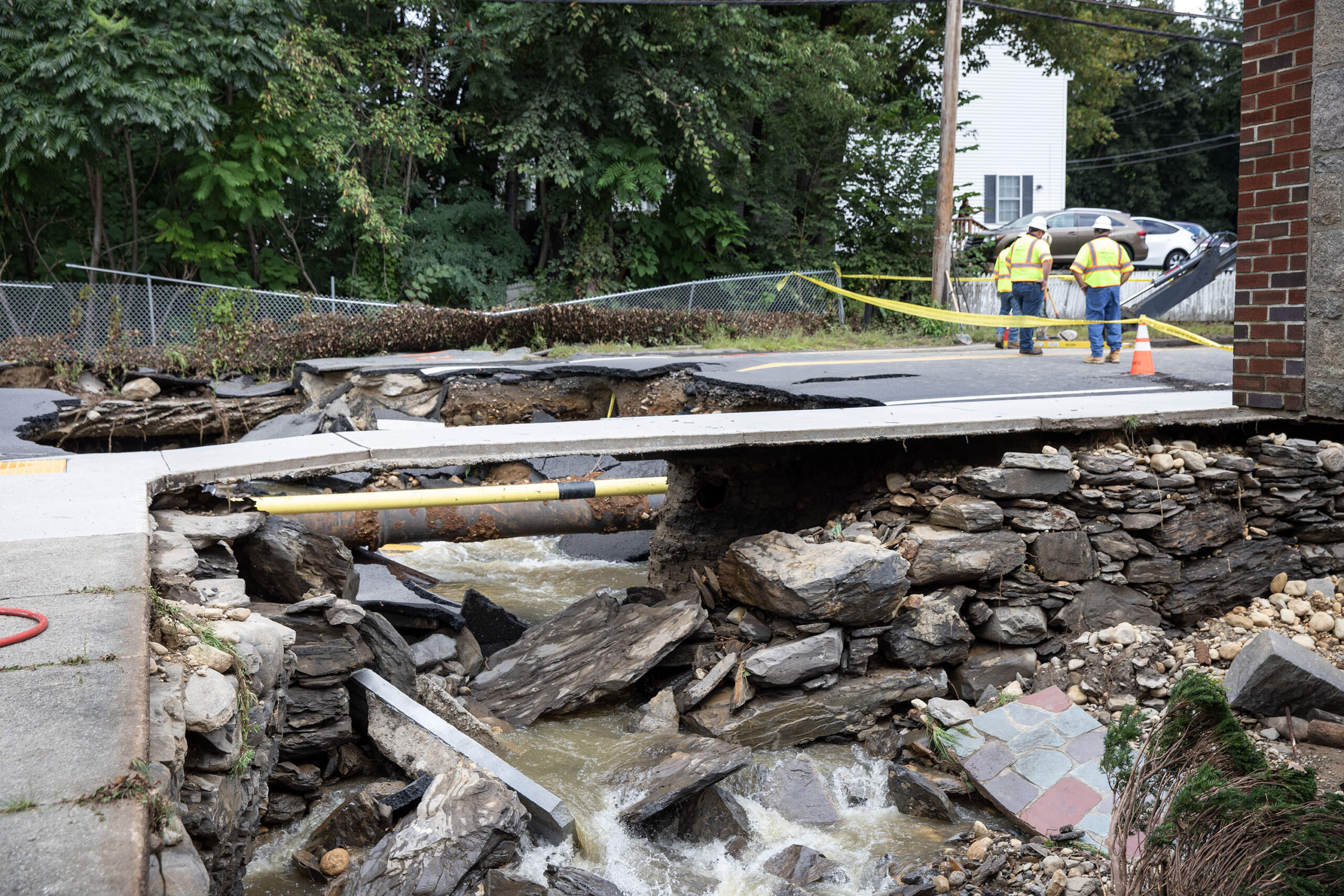 One layer of sidewalk is all the water left behind on a section of Chestnut Street in Leominster, where flood waters swept away the road. (Robin Lubbock/WBUR)